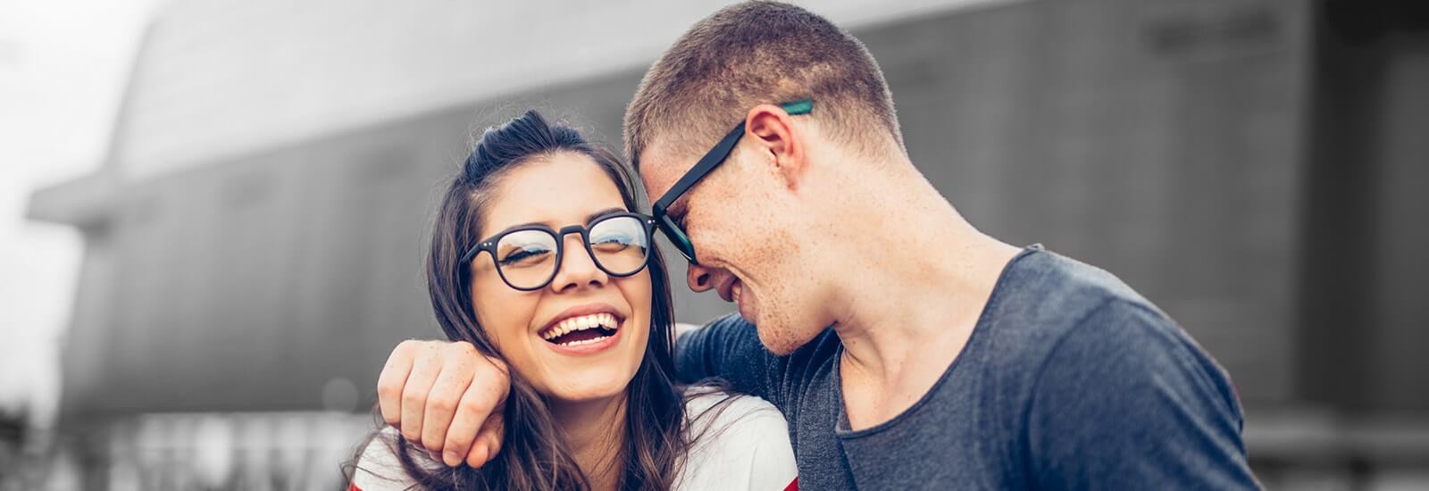 A romantic couple laughing and embracing each other