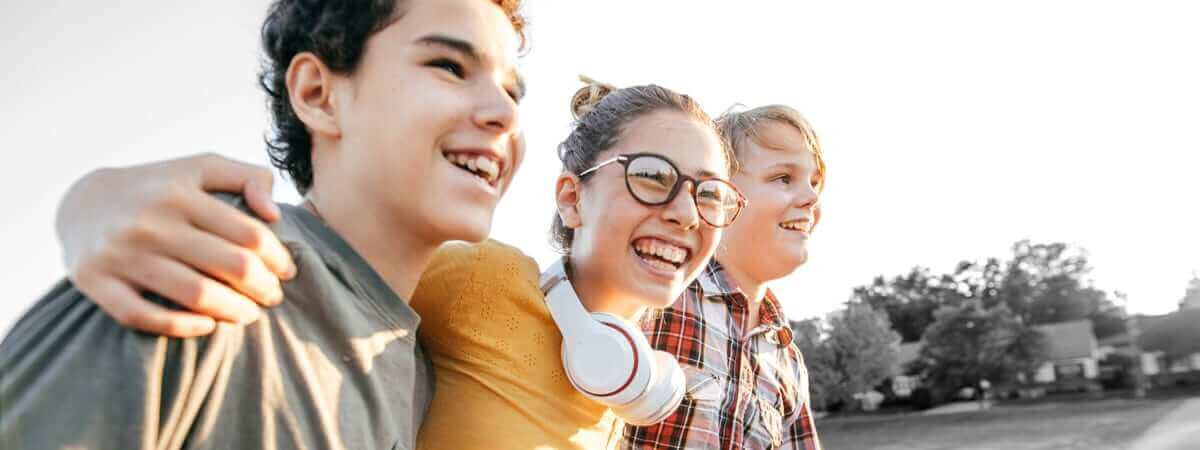 Friends from school are laughing and hanging out together outside