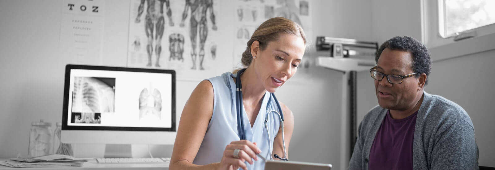 A doctor is going over charts with their patient