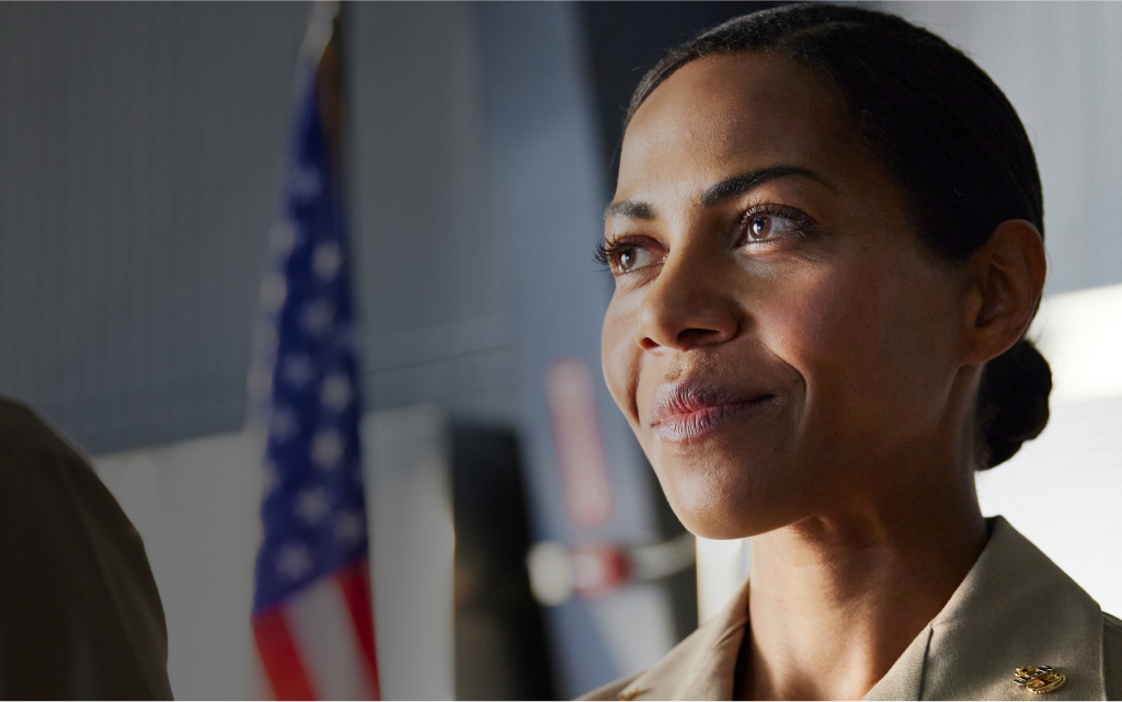 Woman in military attire smiling.